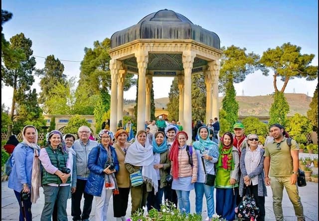 Group tour visiting ancient ruins in Iran